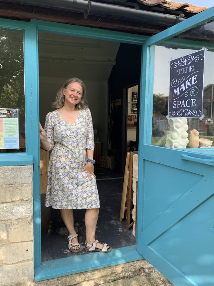 Josephine Corcoran standing in the door way of a studio space next to an open blue door