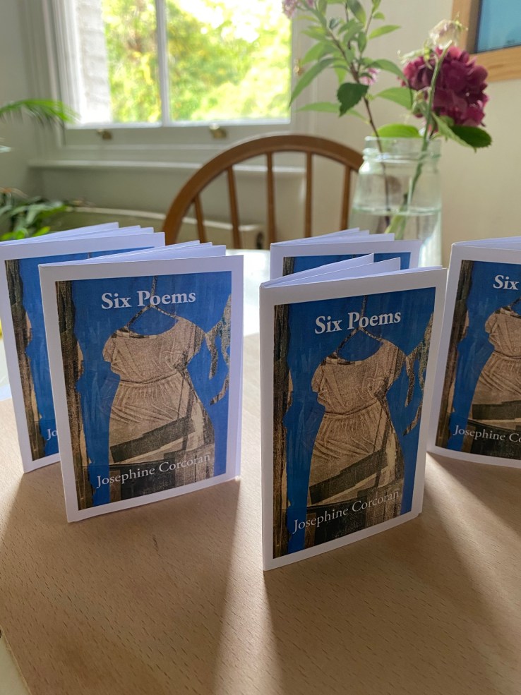 Josephine Corcoran's zine 'Six Poems' arranged upright on a small table, flowers in the background