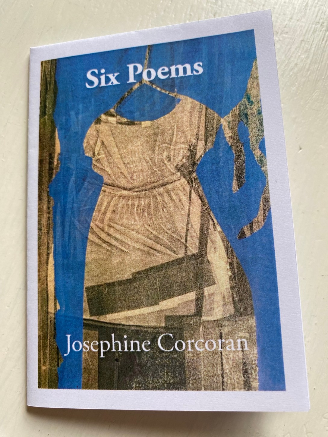 Cover of 'Six Poems' by Josephine Corcoran featuring an intaglio print by Pauline Scott-Garrett, a child's white dress on a blue background